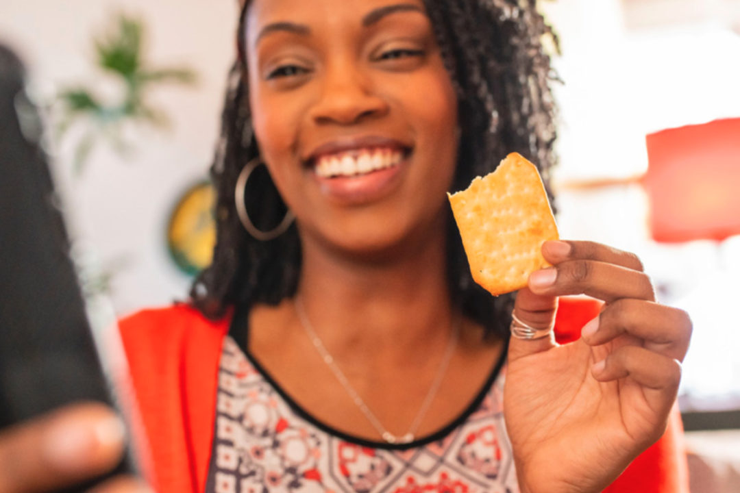 Woman snacking on Ritz crackers