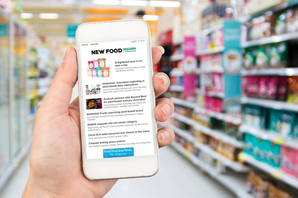 New Food Insider newsletter on phone in supermarket