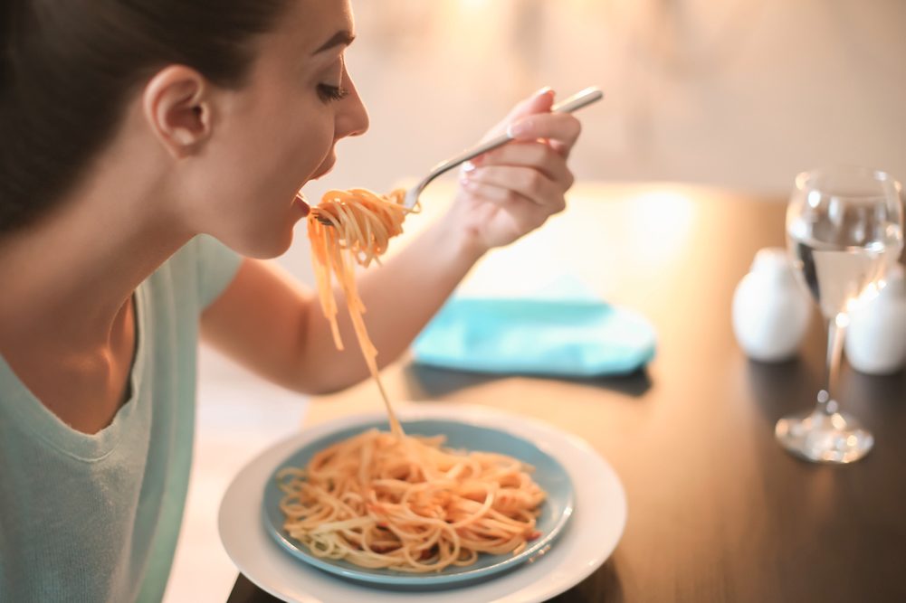 Woman eating pasta