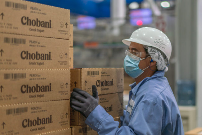 Chobani employee with Chobani boxes