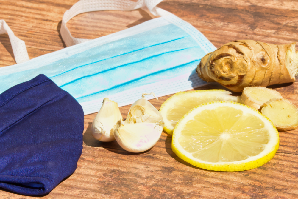 Immunue-boosting ingredients on a table next to face masks
