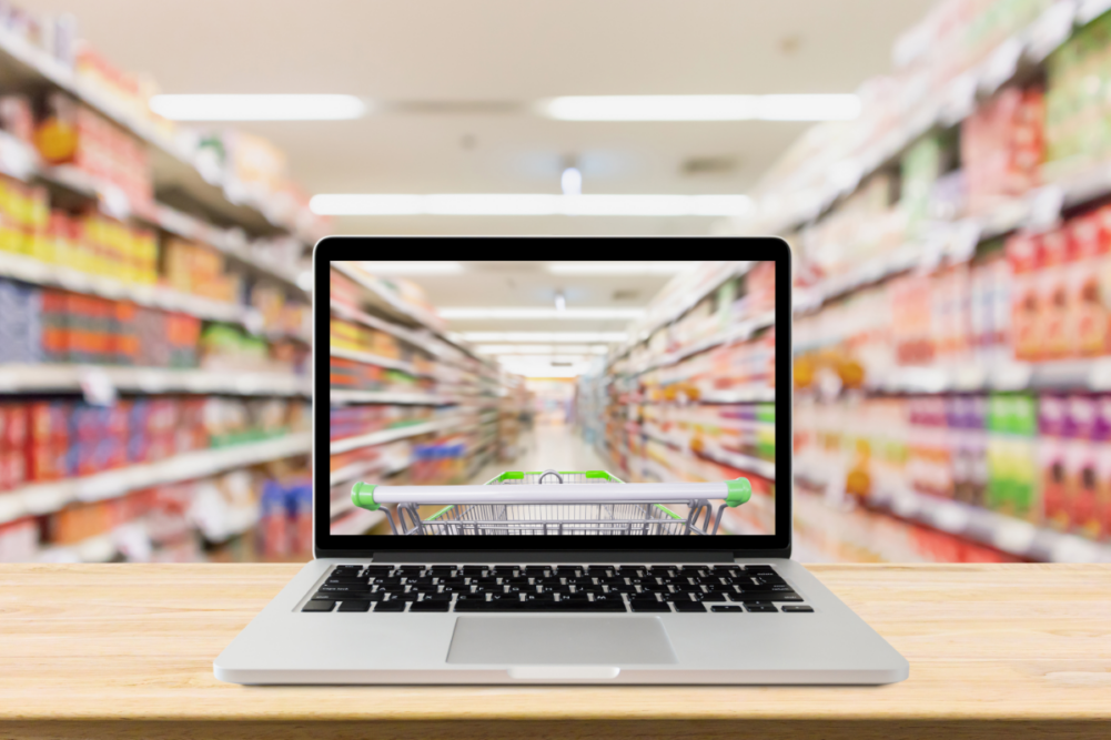 Computer screen in front of grocery store shelf