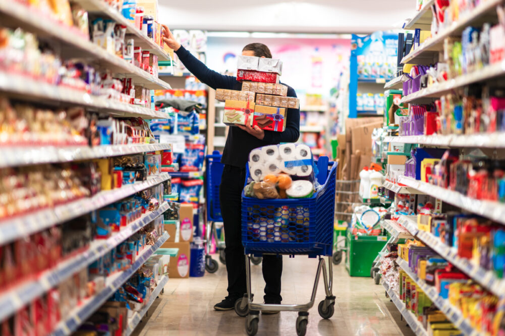 Man buying a lot of packaged foods at the supermarket