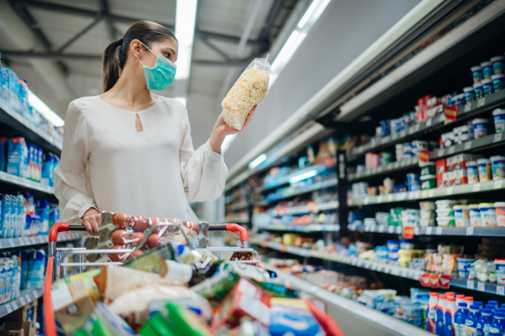 Woman with mask grocery shopping