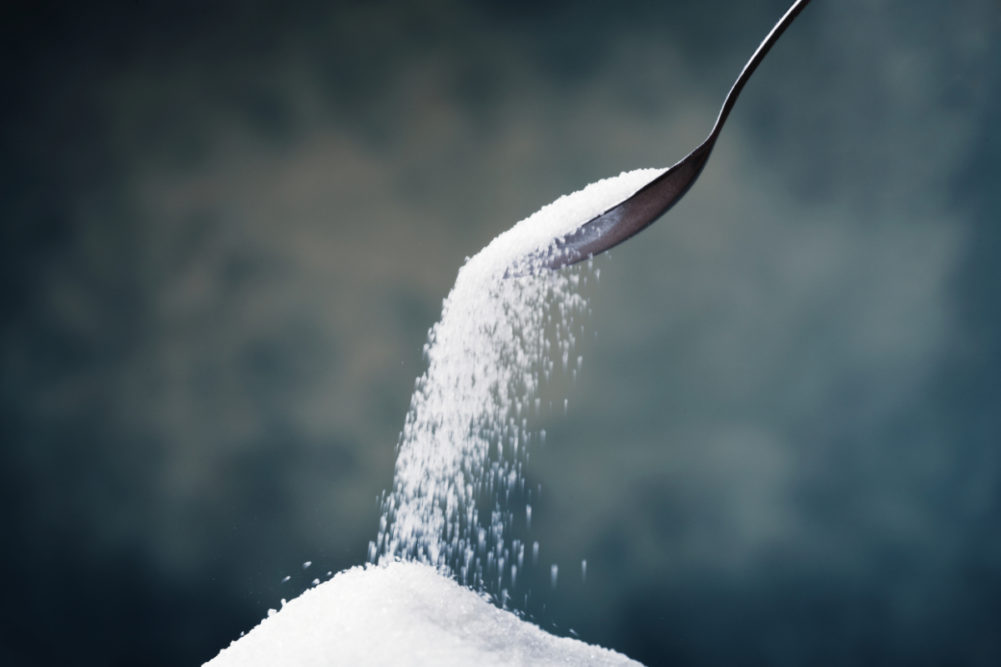 Spoon pouring out sugar