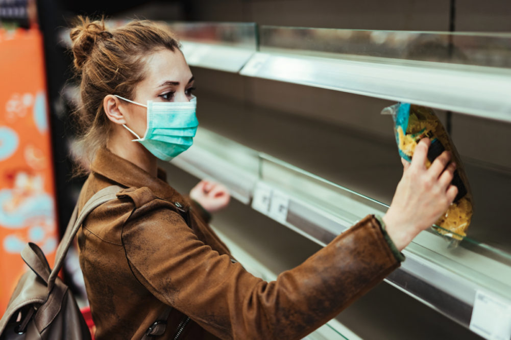 Millennial woman grocery shopping during coronavirus pandemic