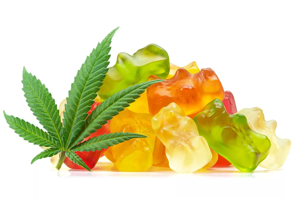 Candies Infused with CBD or THC, with Cannabis Leaf Isolated on White Background