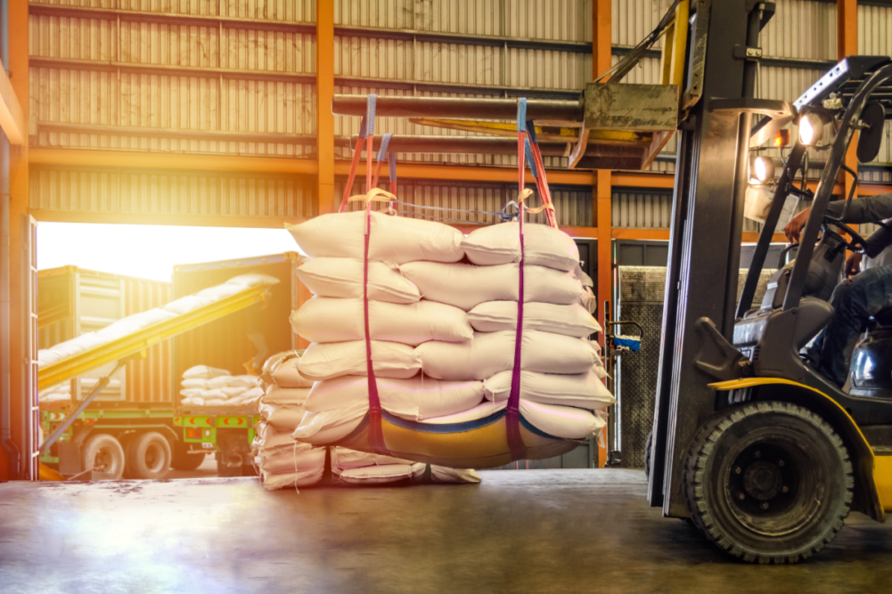 Forklift handling sugar bag for stuffing into container for export