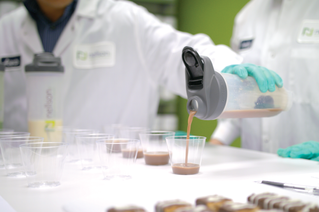 Food scientists testing a protein shake in a test kitchen