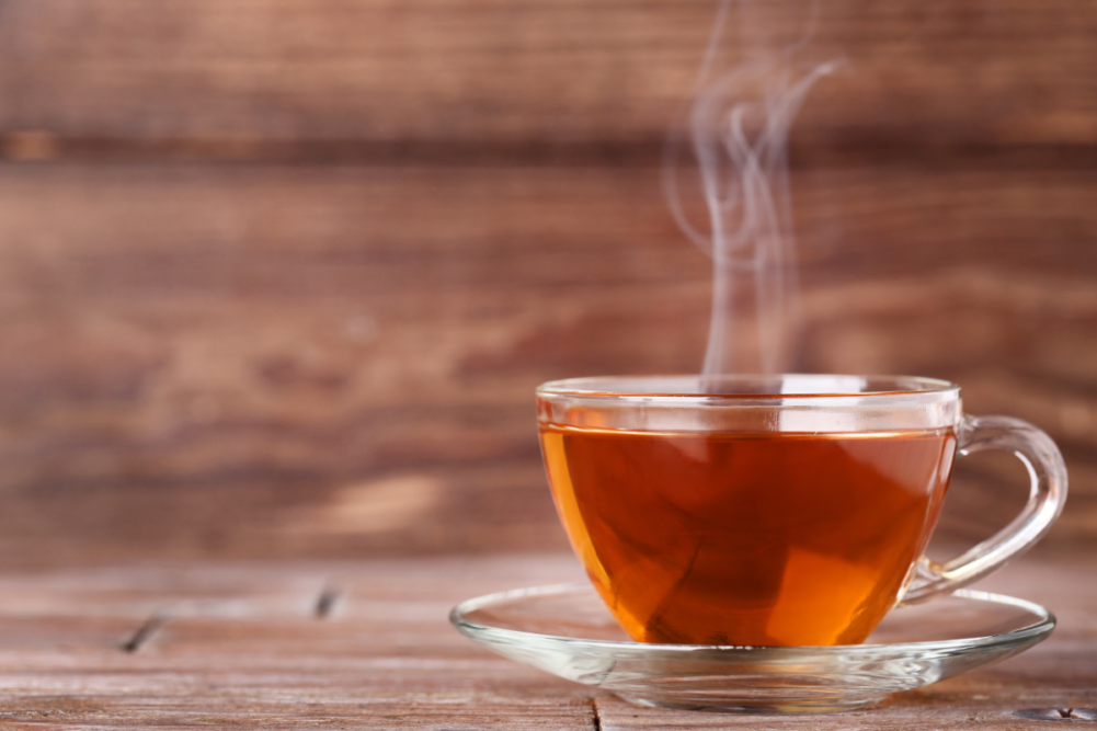 cup of hot tea on wooden table