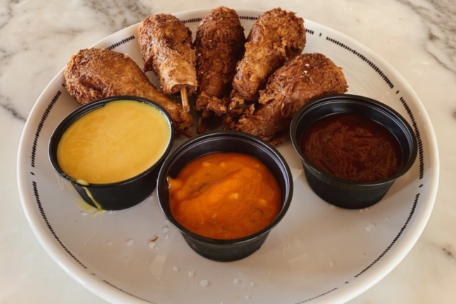 Plant-based chicken wing alternatives from Sundial Foods on plate with dipping sauce