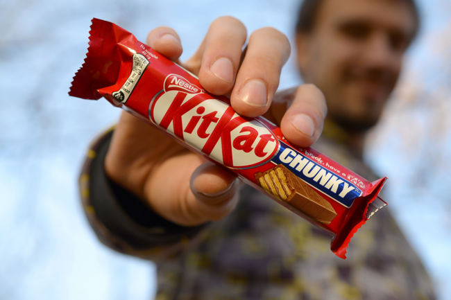 Consumer holding KitKat bar