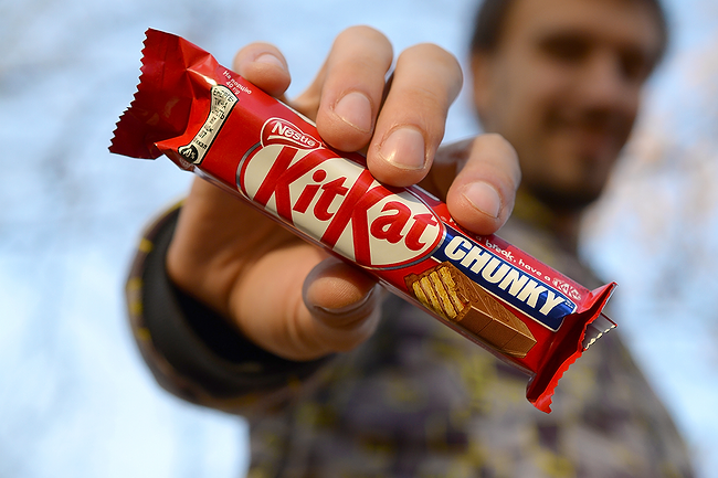 Consumer holding KitKat bar