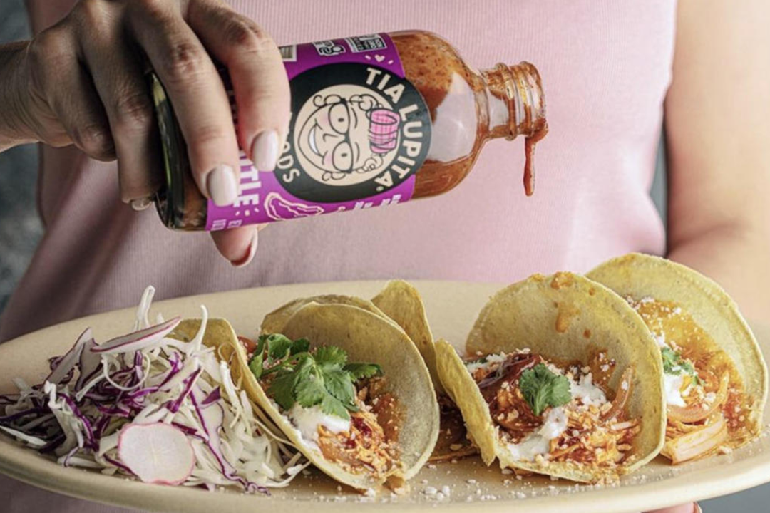Tia Lupita hot sauce drizzled on soft tacos