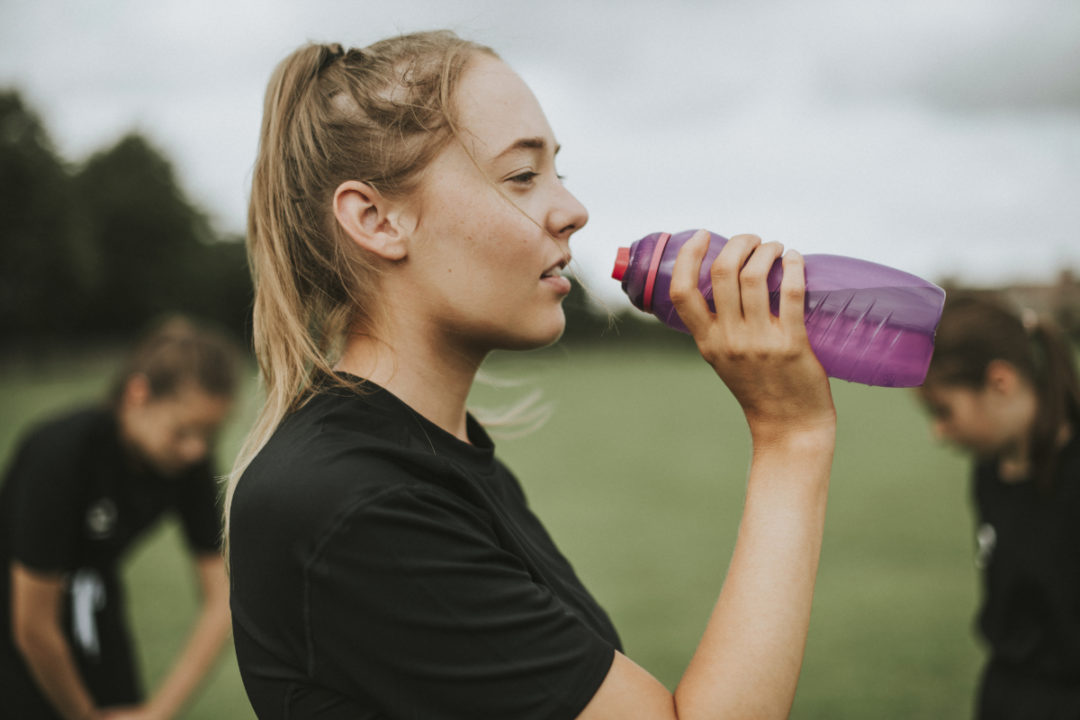 Athlete drinking from water bottle