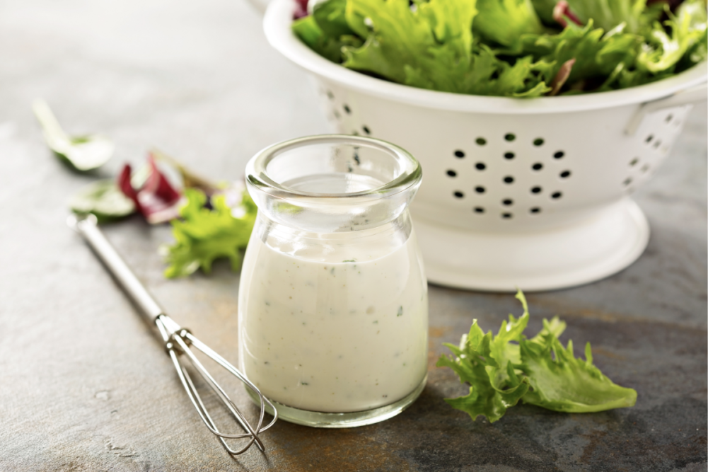 Homemade creamy plant-based salad dressing in glass bottle