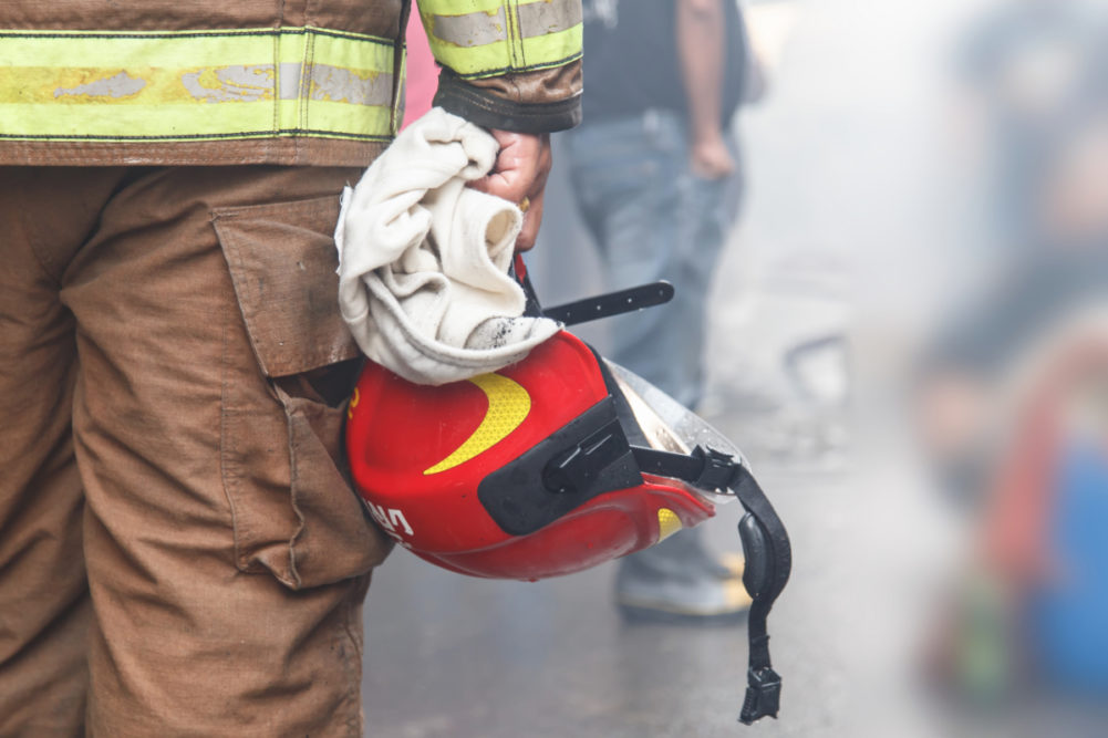 Firefighter holding his helmet