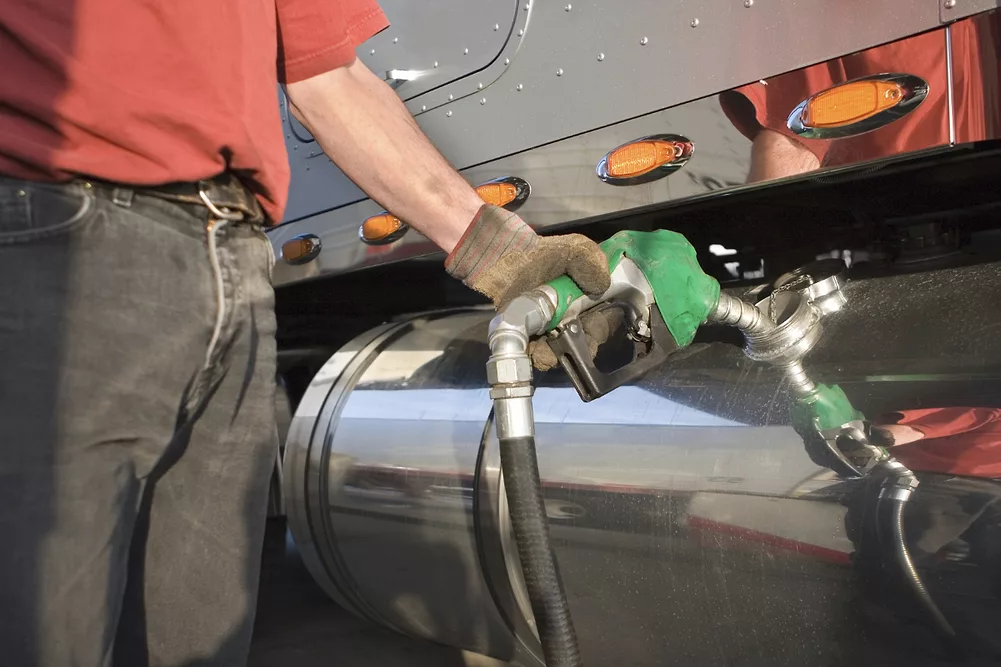 Man fueling up a transport truck