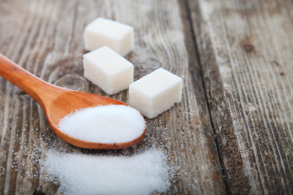 Sugar cubes and sugar in a spoon