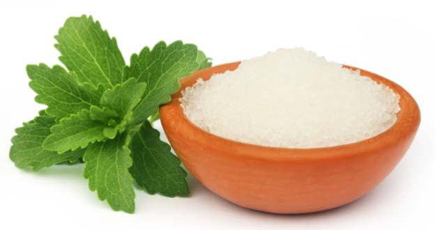 stevia leaf next to a bowl of sugar