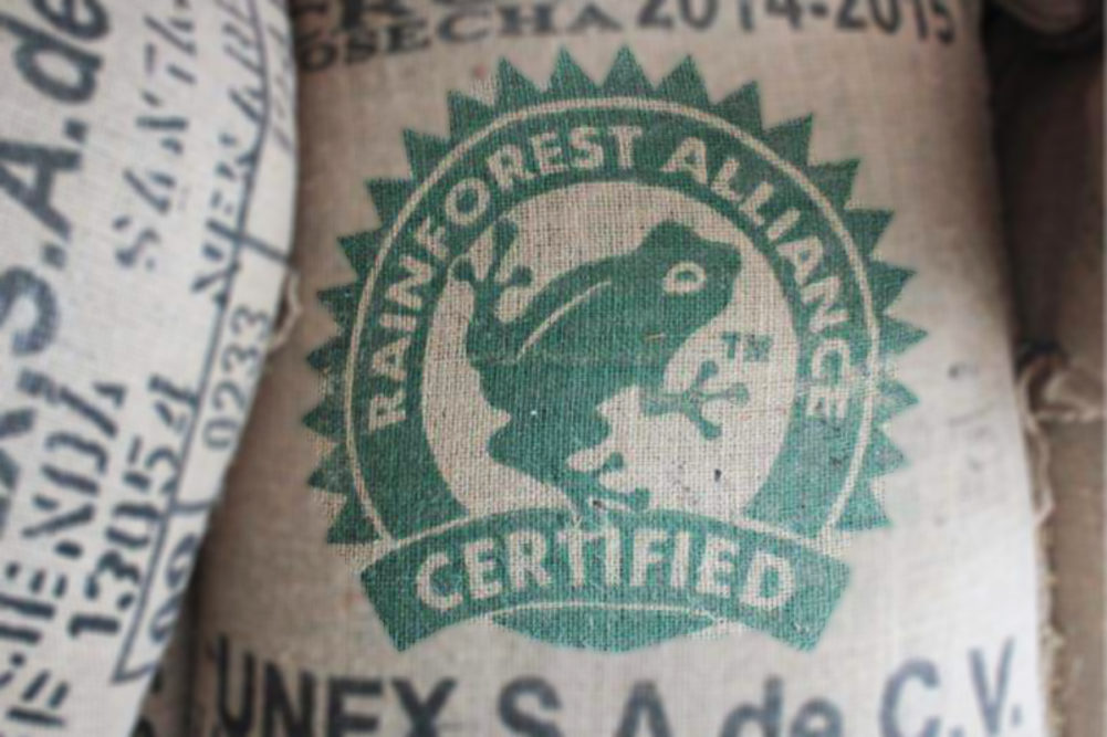 Rainforest Alliance Certified logo on burlap sack of coffee beans