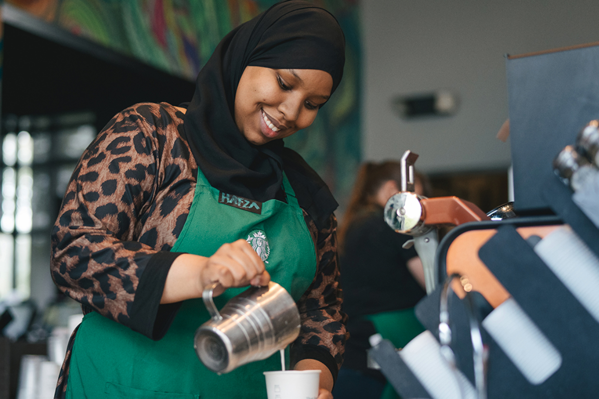 Starbucks barista pouring a drink