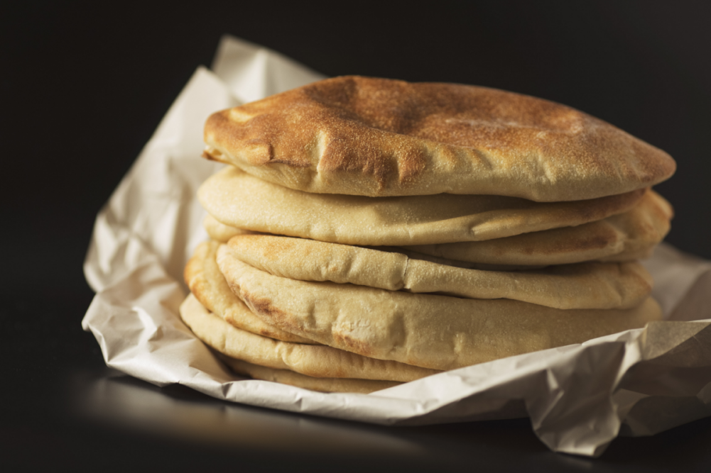 stack of pita bread on black background