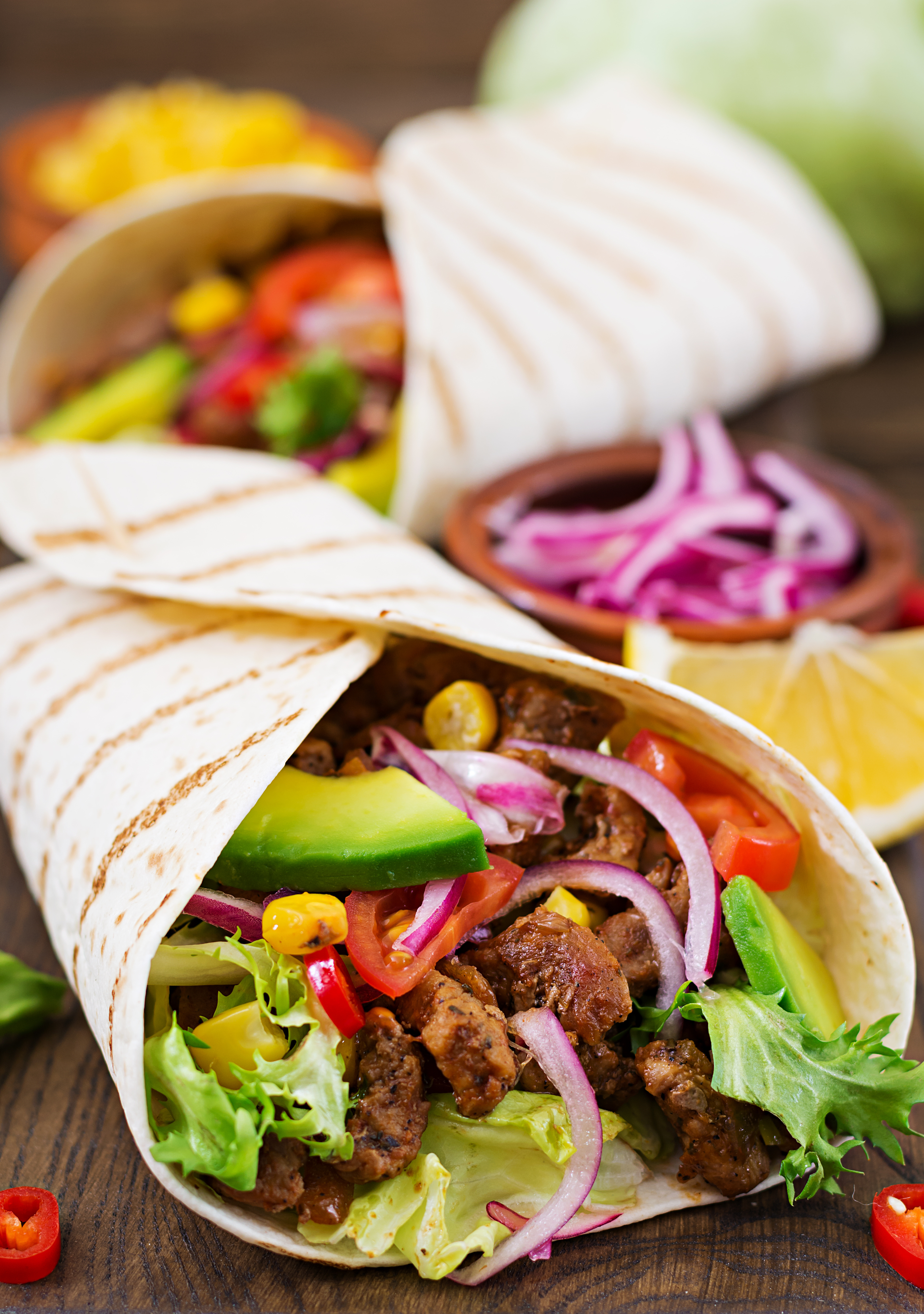 Mexican tacos with beef in tomato sauce and avocado salsa