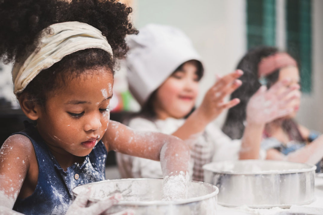 Children playing in raw flour