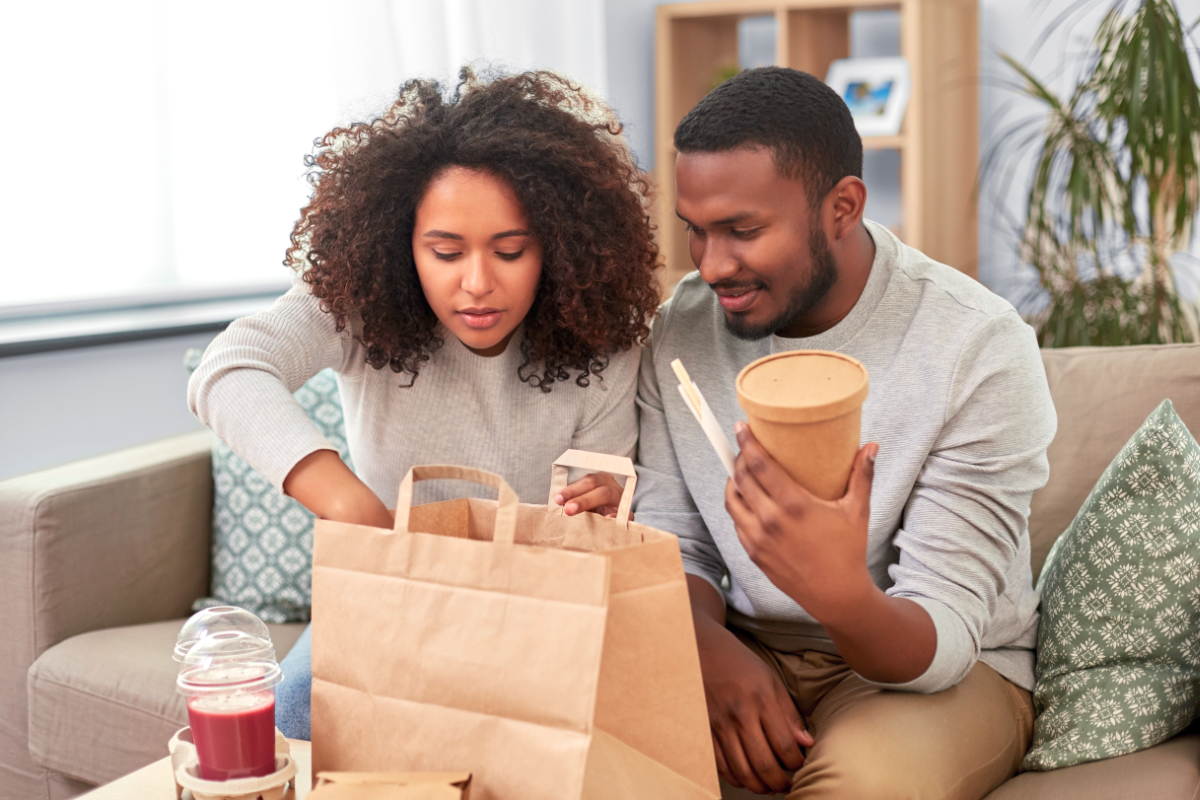 Couple eating restaurant takeout food at home