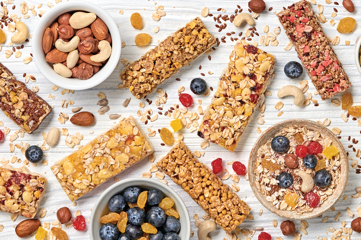 snack bars and healthy snack ingredients on white background