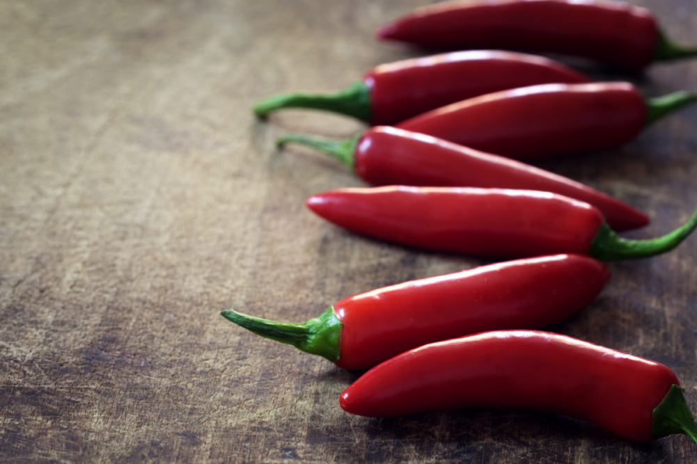 Red chilis on wooden table