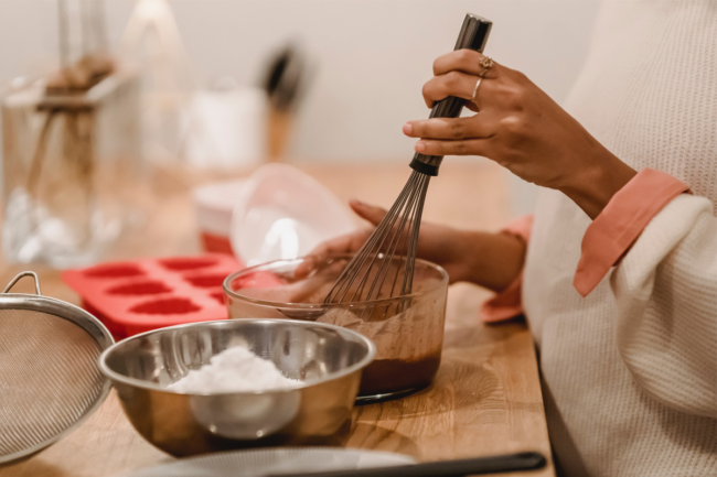 A person whisking while baking