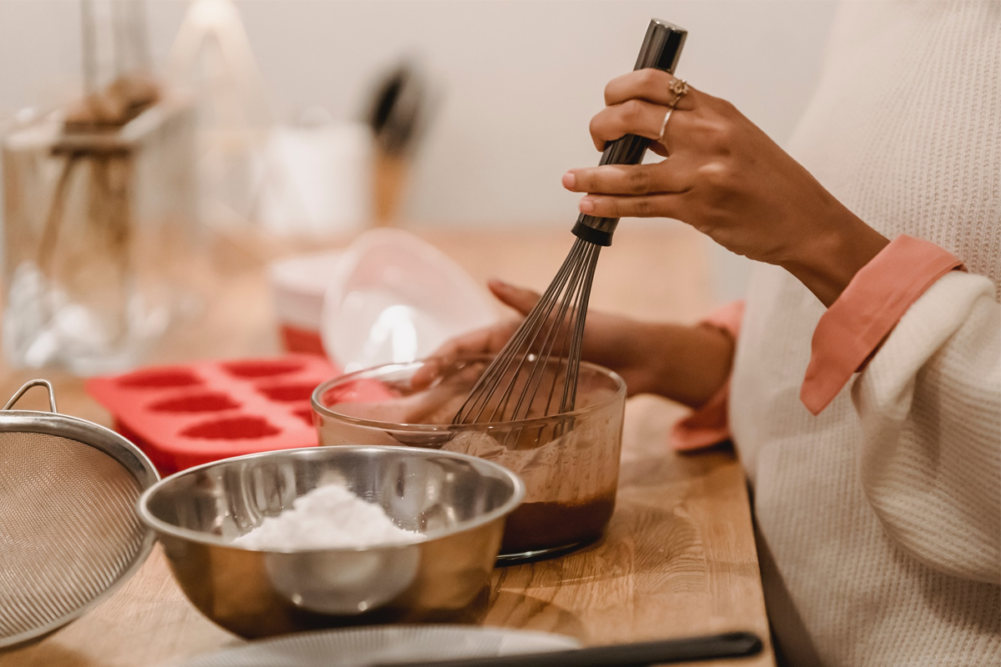 A person whisking while baking