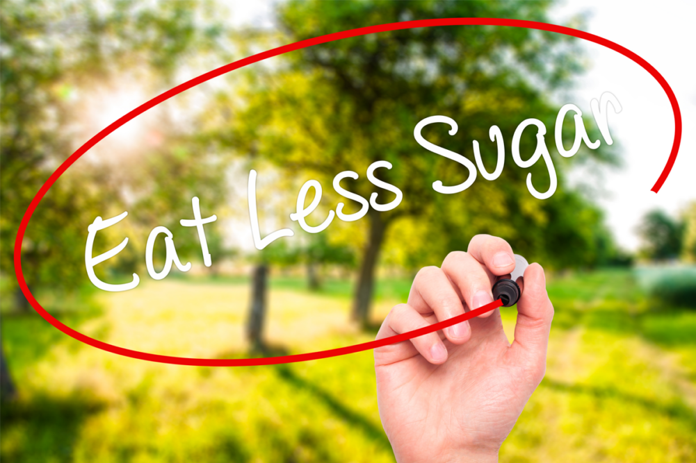 Board with Eat Less Sugar written on it