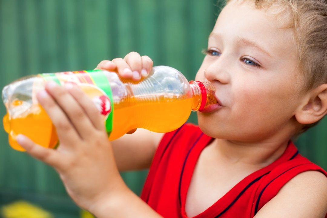 Child drinking orange soda