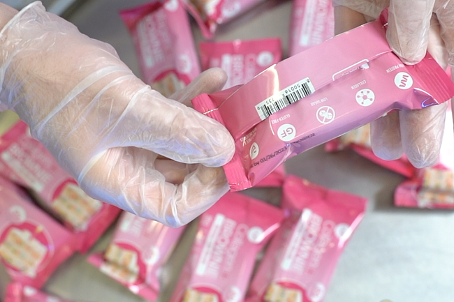 Master Foods Lab worker checking granola bar