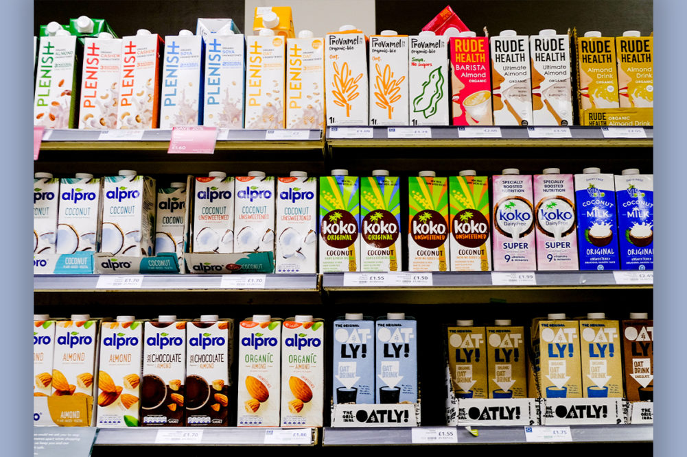 Supermarket shelf of non-dairy milk options