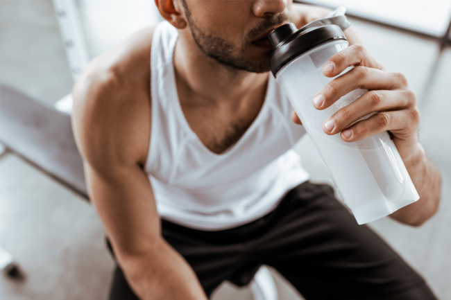 Man drinking from protein bottle