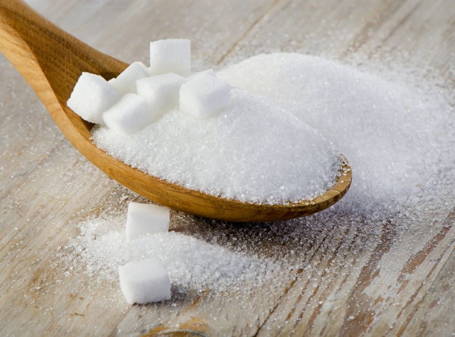 Sugar cubes in a wooden spoon