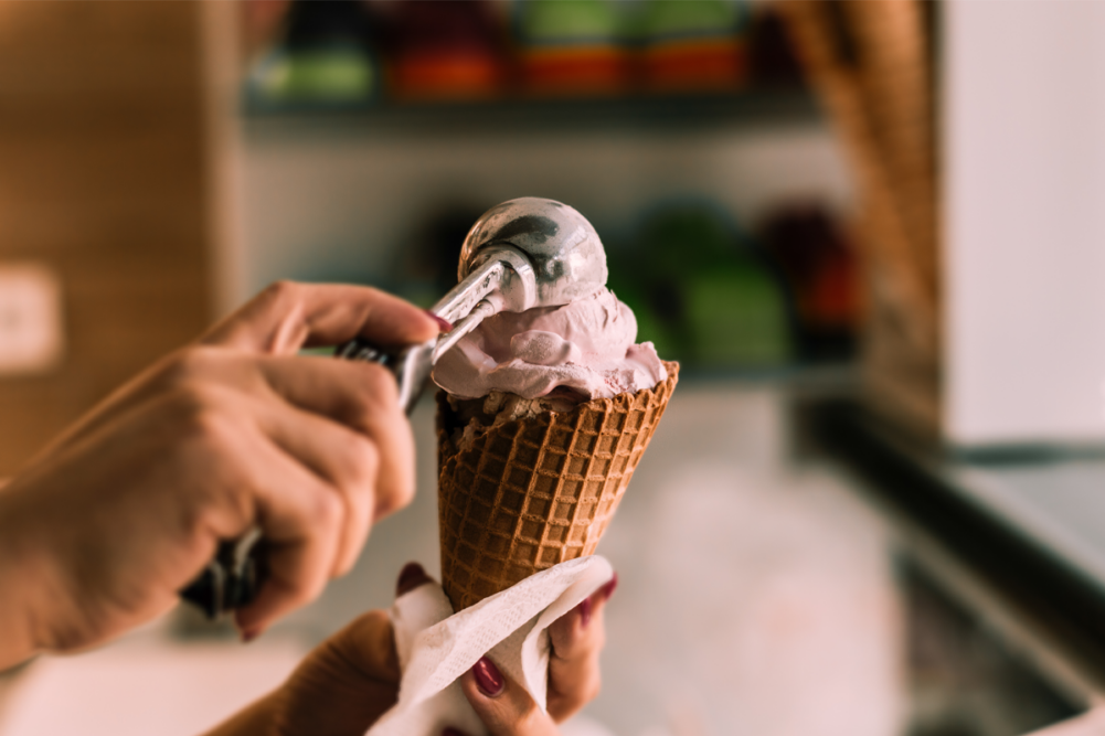 Ice cream being scooped into a cone