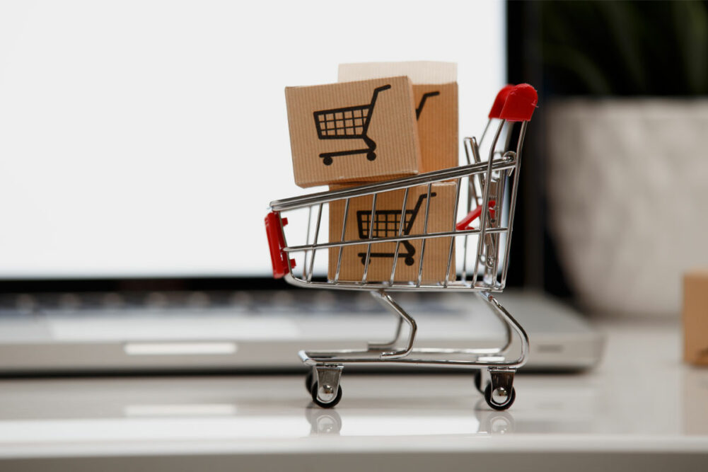 Paper boxes in a shopping cart on a laptop keyboard