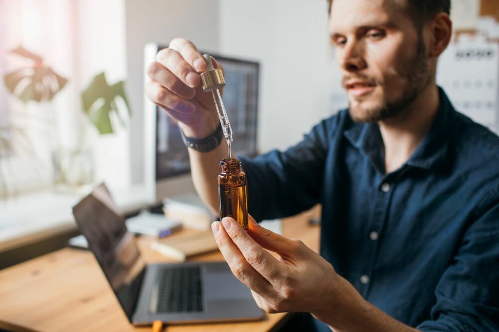 Man making CBD tincture