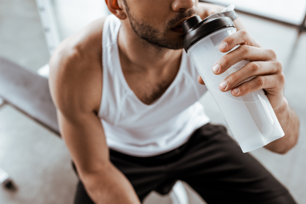 Person drinking from a blender bottle