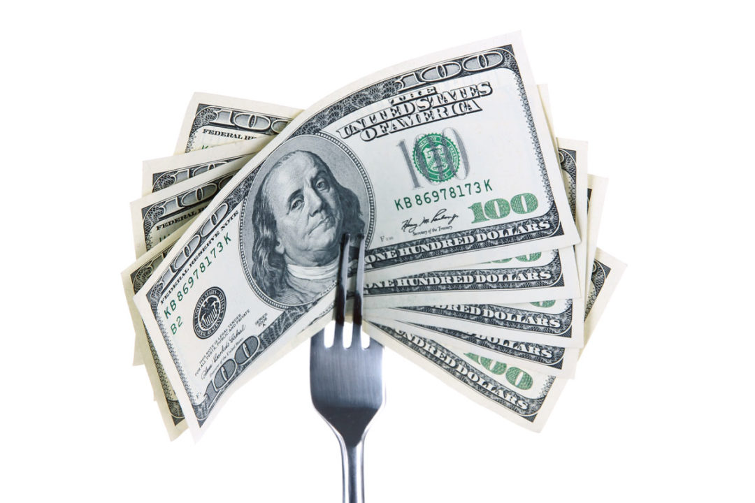 Hundred dolar bills on a fork