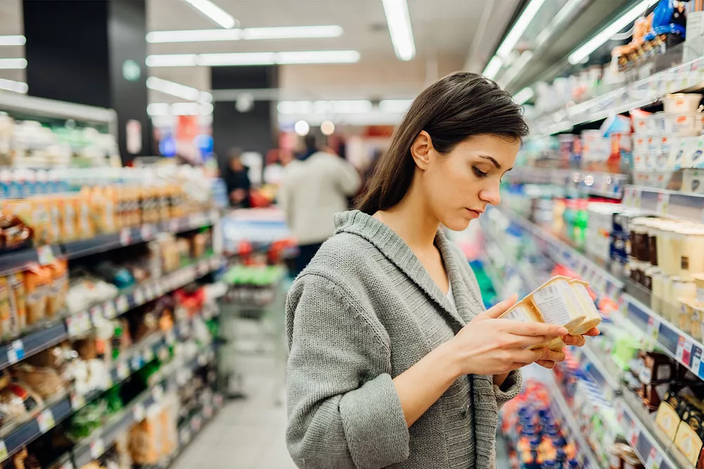 Woman reading a label in a supermarket
