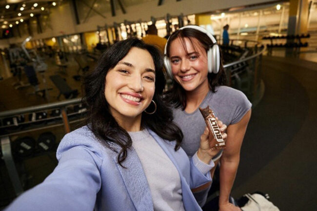 Two women holding a Built Bar