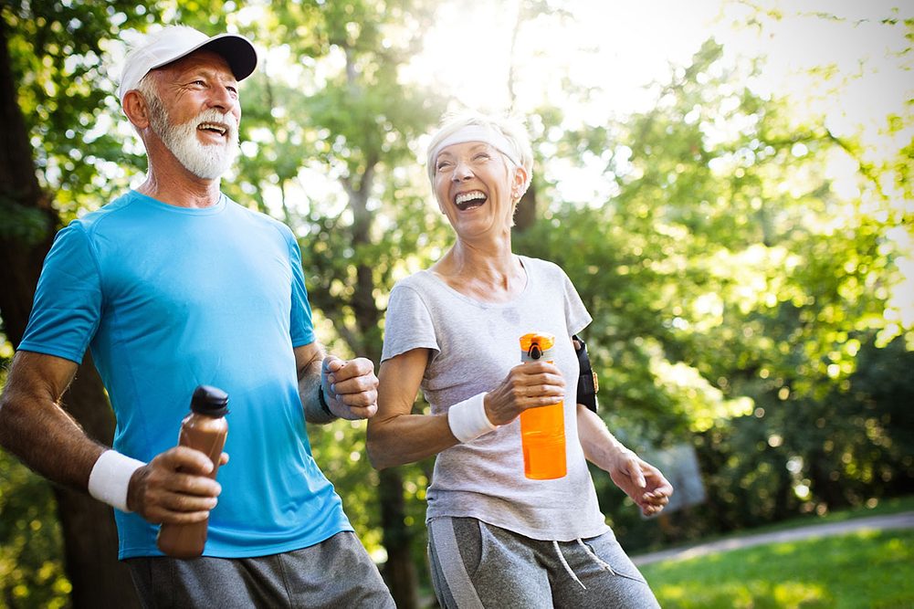 An elderly couple working out