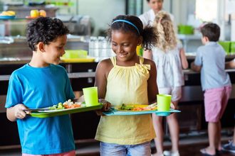 Children carrying school lunch trays