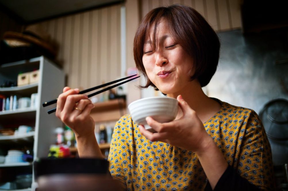 Woman eating food from a bowl
